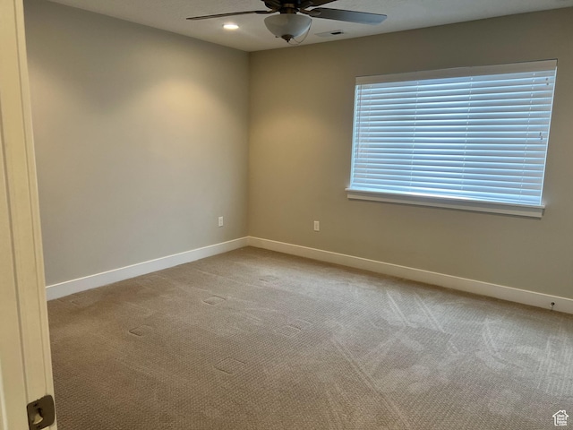 spare room with baseboards, recessed lighting, ceiling fan, and light colored carpet