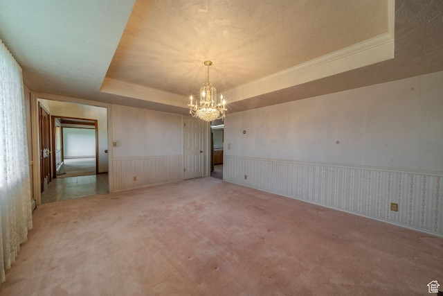 1952 W 8600 N, Neola, UT 84053 - empty room with a wainscoted wall, a tray ceiling, light carpet, crown molding, and a notable chandelier