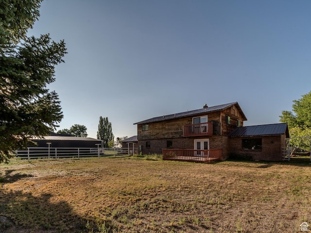1952 W 8600 N, Neola, UT 84053 - exterior space with fence, a balcony, french doors, a lawn, and metal roof