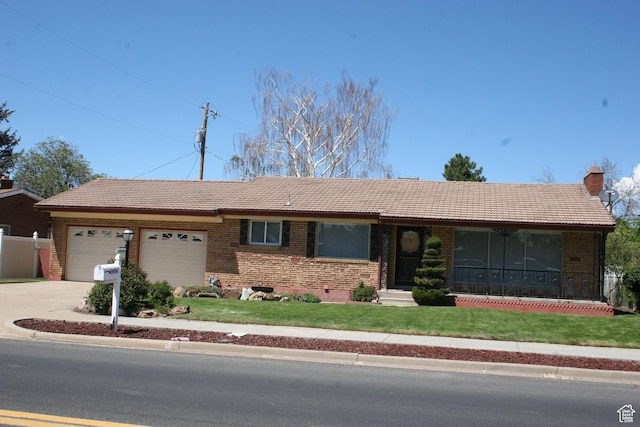 1974 W 5200 S, Roy, UT 84067 - ranch-style house with a tile roof, a front lawn, and brick siding