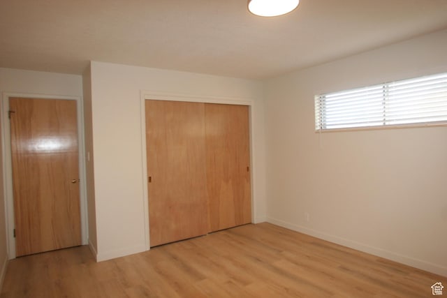 1974 W 5200 S, Roy, UT 84067 - unfurnished bedroom with light wood finished floors, a closet, and baseboards