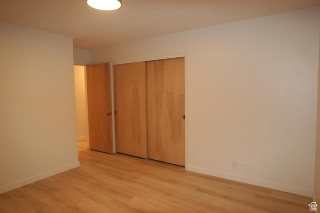 1974 W 5200 S, Roy, UT 84067 - unfurnished bedroom with light wood-type flooring, baseboards, and a closet
