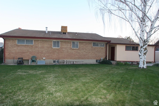 1974 W 5200 S, Roy, UT 84067 - back of house featuring a chimney, a lawn, and brick siding