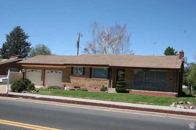 1974 W 5200 S, Roy, UT 84067 - ranch-style home featuring a tile roof, a front yard, an attached garage, and brick siding