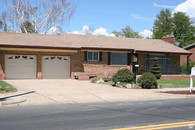 1974 W 5200 S, Roy, UT 84067 - ranch-style home with a tile roof, an attached garage, driveway, and brick siding