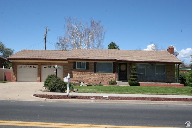 1974 W 5200 S, Roy, UT 84067 - single story home with a tile roof, brick siding, an attached garage, a front lawn, and driveway