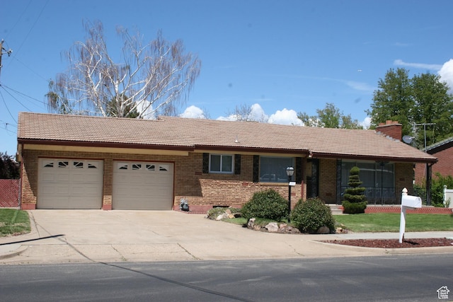 1974 W 5200 S, Roy, UT 84067 - single story home with a tile roof, an attached garage, driveway, brick siding, and a porch