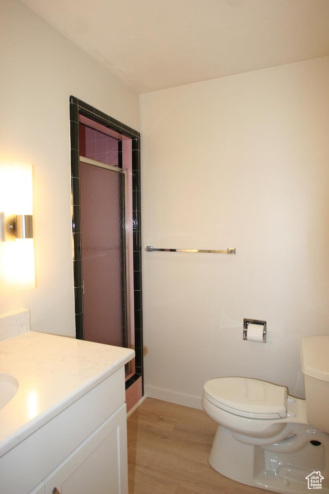 1974 W 5200 S, Roy, UT 84067 - bathroom featuring wood finished floors, toilet, a shower stall, and vanity