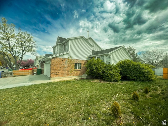 1689 W Crystal Ridge Dr S, West Jordan, UT 84084 - view of side of home with fence, driveway, brick siding, and a yard