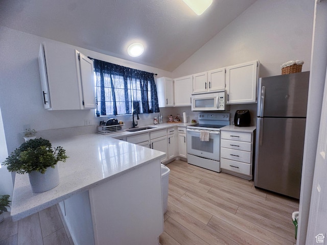 1689 W Crystal Ridge Dr S, West Jordan, UT 84084 - kitchen featuring white cabinets, lofted ceiling, a sink, white appliances, and a peninsula