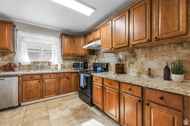 kitchen featuring a sink, brown cabinetry, stainless steel appliances, backsplash, and under cabinet range hood