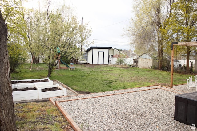 343 N 200 W, Brigham City, UT 84302 - view of yard with a playground, a vegetable garden, fence, an outbuilding, and a storage unit