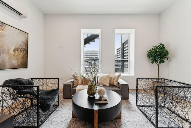 living area featuring a wall mounted air conditioner and wood finished floors