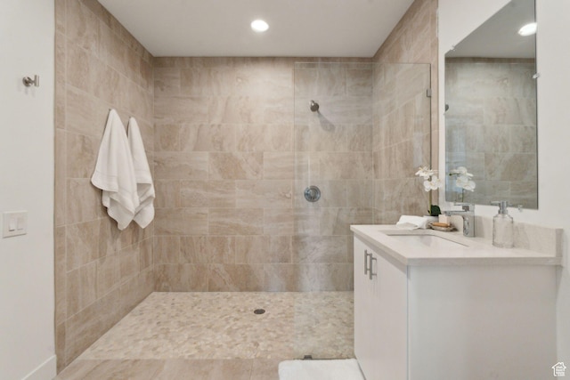 full bath featuring walk in shower, vanity, and recessed lighting