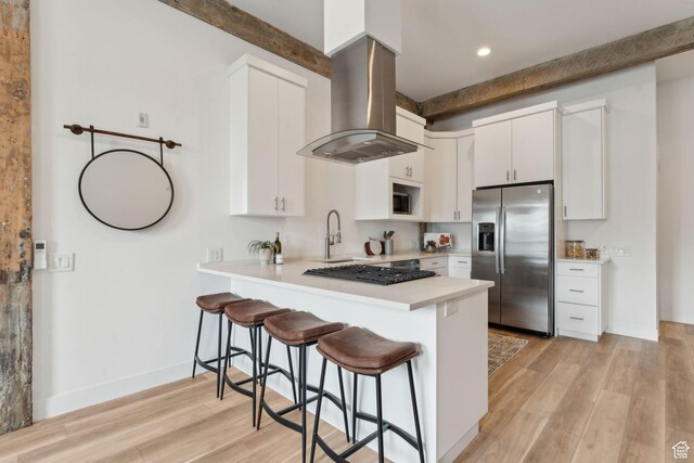 kitchen with stainless steel fridge with ice dispenser, island exhaust hood, a sink, a peninsula, and gas cooktop