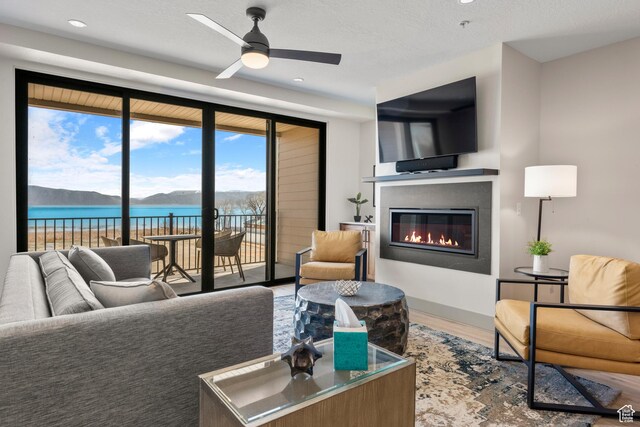 35 E 150 S Unit E301, Garden City, UT 84028 - living room featuring a ceiling fan, a glass covered fireplace, wood finished floors, and recessed lighting