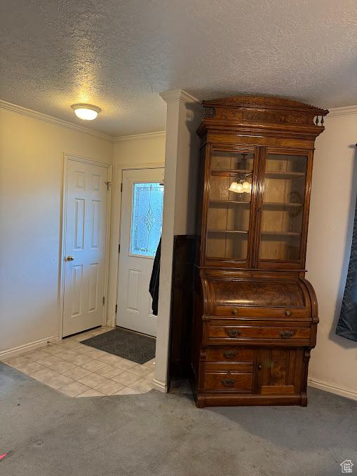 1006 S 1040 W, Payson, UT 84651 - foyer entrance with a textured ceiling, ornamental molding, light carpet, baseboards, and light tile patterned flooring