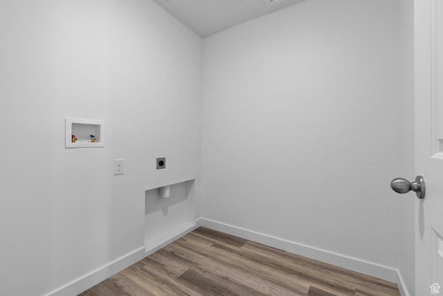 washroom with wood finished floors, hookup for an electric dryer, baseboards, laundry area, and washer hookup