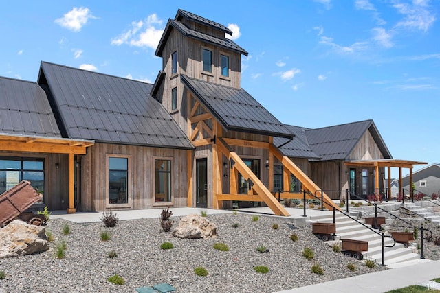 rear view of property with a standing seam roof and metal roof
