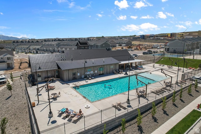 pool featuring fence, a residential view, and a patio