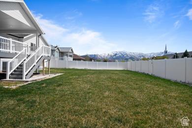 1065 W 275 S, Tremonton, UT 84337 - view of yard with a wooden deck, a fenced backyard, and stairs