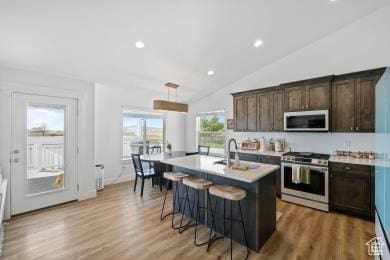 1065 W 275 S, Tremonton, UT 84337 - kitchen featuring a sink, dark brown cabinetry, light countertops, a kitchen bar, and gas stove
