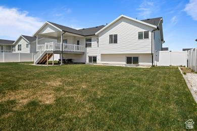 1065 W 275 S, Tremonton, UT 84337 - back of house with stairway, a fenced backyard, a yard, and a deck