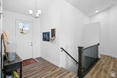1065 W 275 S, Tremonton, UT 84337 - entrance foyer featuring baseboards, wood finished floors, and a notable chandelier