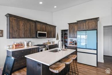 1065 W 275 S, Tremonton, UT 84337 - kitchen with dark brown cabinetry, appliances with stainless steel finishes, a sink, and dark wood-type flooring
