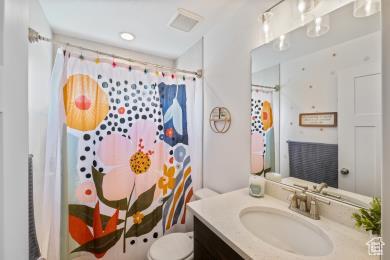1065 W 275 S, Tremonton, UT 84337 - full bathroom featuring visible vents, vanity, curtained shower, and toilet