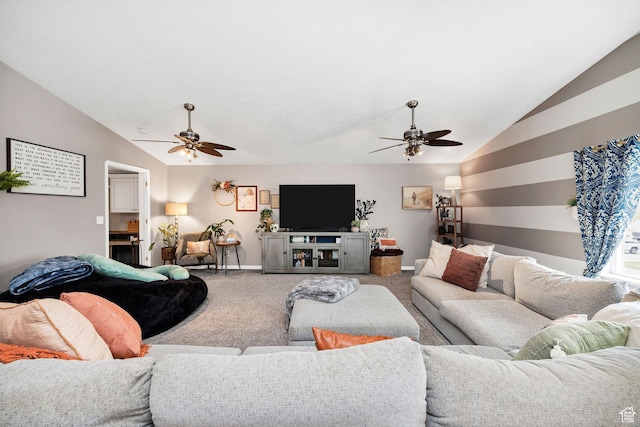 living area with lofted ceiling, a ceiling fan, baseboards, and carpet