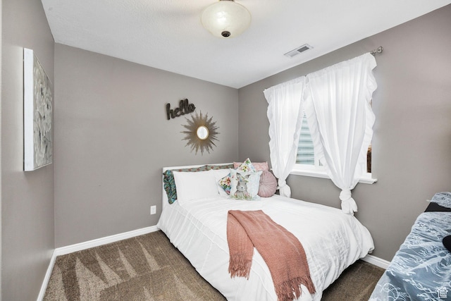 bedroom with baseboards, carpet flooring, and visible vents