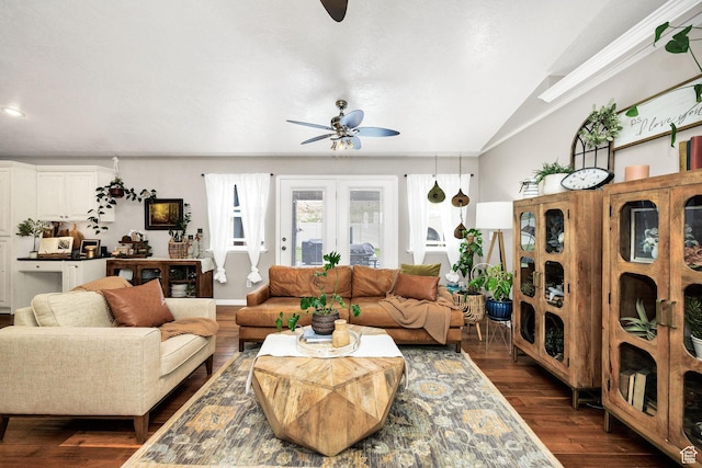 living area featuring dark wood-type flooring, vaulted ceiling, and ceiling fan