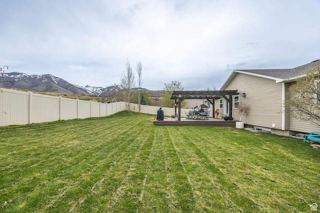 view of yard featuring a pergola, fence, a patio area, and a mountain view