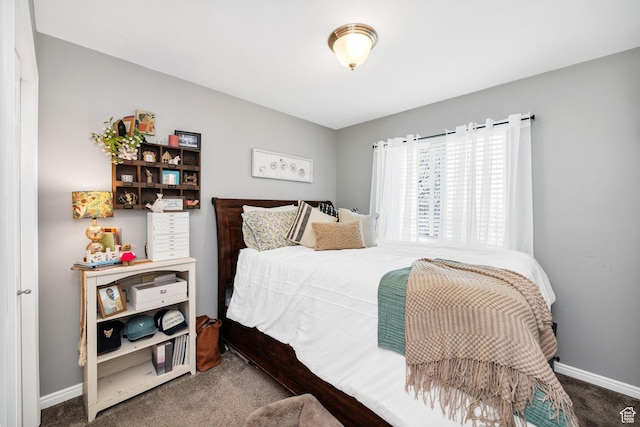 bedroom with carpet floors and baseboards