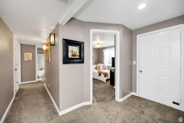 corridor featuring carpet and baseboards