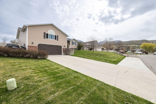 view of property exterior featuring a residential view, concrete driveway, a garage, brick siding, and a lawn
