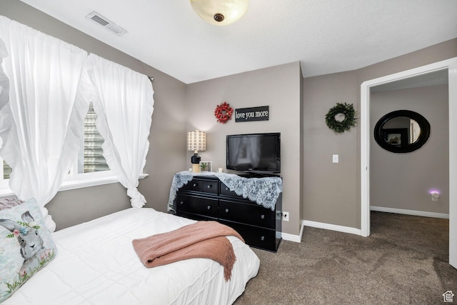 carpeted bedroom featuring baseboards and visible vents