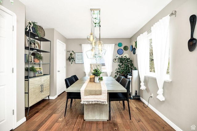 dining area with a chandelier, wood-type flooring, baseboards, and plenty of natural light