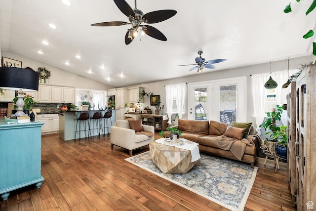 living area with recessed lighting, vaulted ceiling, wood-type flooring, and a ceiling fan