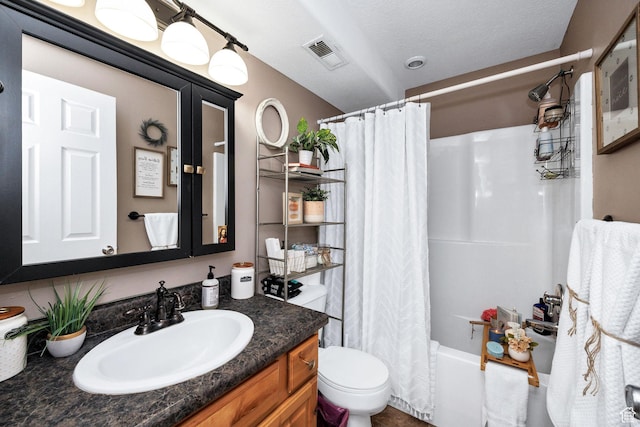 bathroom featuring shower / bath combo with shower curtain, visible vents, vanity, and toilet
