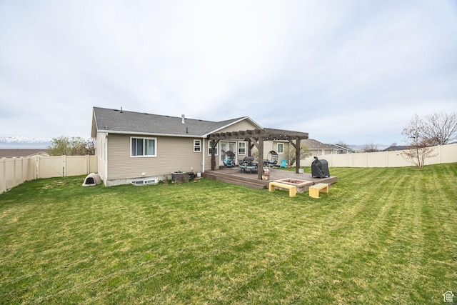 rear view of house featuring a lawn, a pergola, a fenced backyard, and a wooden deck