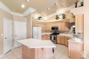 150 S Crystal Lakes Dr Unit 51, St George, UT 84770 - kitchen with stainless steel appliances, light countertops, light brown cabinetry, light tile patterned flooring, and track lighting