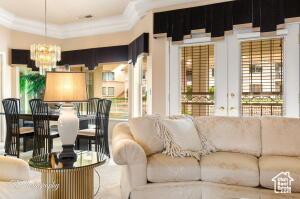 150 S Crystal Lakes Dr Unit 51, St George, UT 84770 - living room featuring a notable chandelier and crown molding