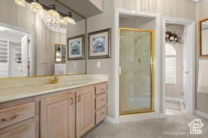 150 S Crystal Lakes Dr Unit 51, St George, UT 84770 - full bath featuring baseboards, a shower stall, and vanity