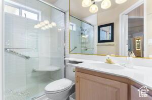 150 S Crystal Lakes Dr Unit 51, St George, UT 84770 - full bathroom featuring toilet, vanity, a shower stall, and a chandelier