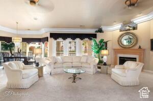 150 S Crystal Lakes Dr Unit 51, St George, UT 84770 - carpeted living area featuring ornamental molding and a fireplace