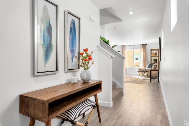 3814 S Landmark Ln Unit 1395, Magna, UT 84044 - hall with light wood-style floors, baseboards, and stairs