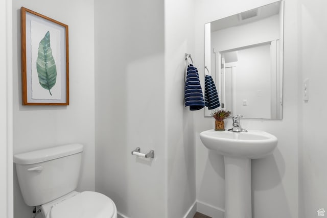 3814 S Landmark Ln Unit 1395, Magna, UT 84044 - bathroom with toilet, baseboards, and a sink