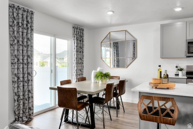 3814 S Landmark Ln Unit 1395, Magna, UT 84044 - dining room featuring baseboards, light wood finished floors, and recessed lighting